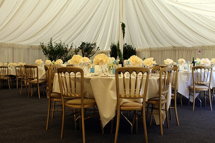 Elegant Wedding Banquet Table Setting With Gold Chiavari Chairs