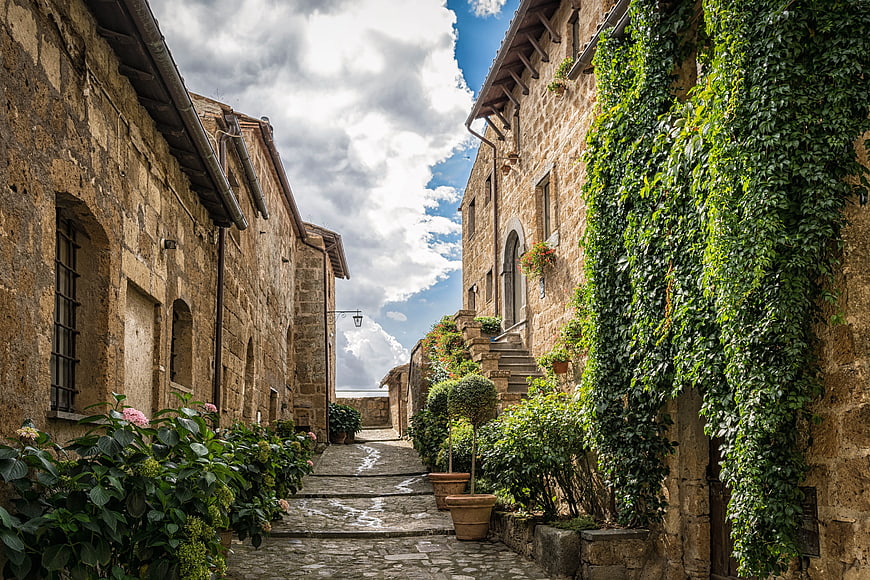 Narrow cobblestone street in historic European village with stone houses