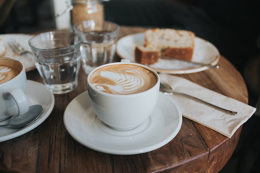 Latte Art Coffee and Cake on Rustic Wooden Table