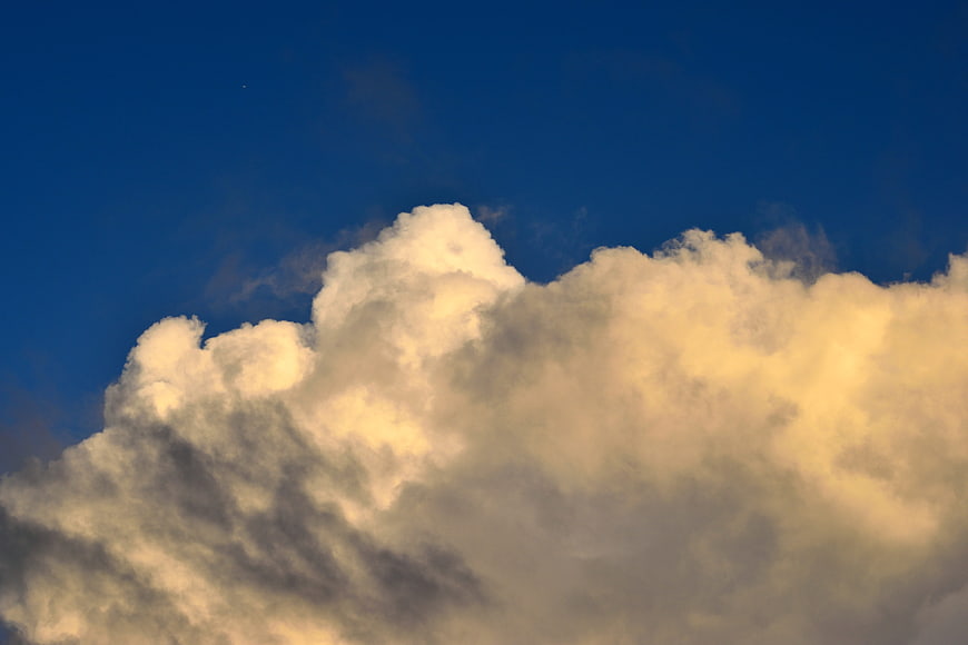 Dramatic Cumulus Clouds Against Deep Blue Sky