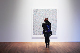 Woman Viewing Abstract Art in Minimalist Gallery