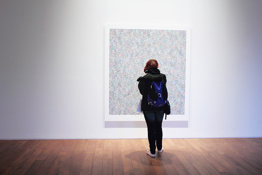 Woman Viewing Abstract Art in Minimalist Gallery