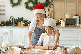 Grandmother and granddaughter baking Christmas cookies together