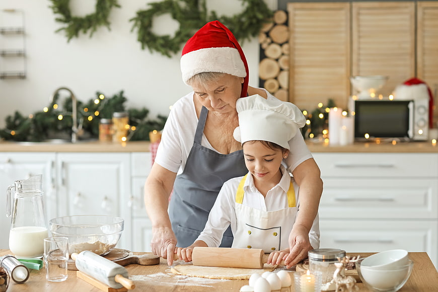 Grandmother and granddaughter baking Christmas cookies together