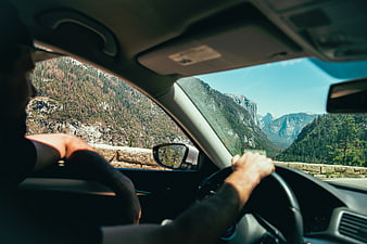 Man driving car through scenic mountain landscape