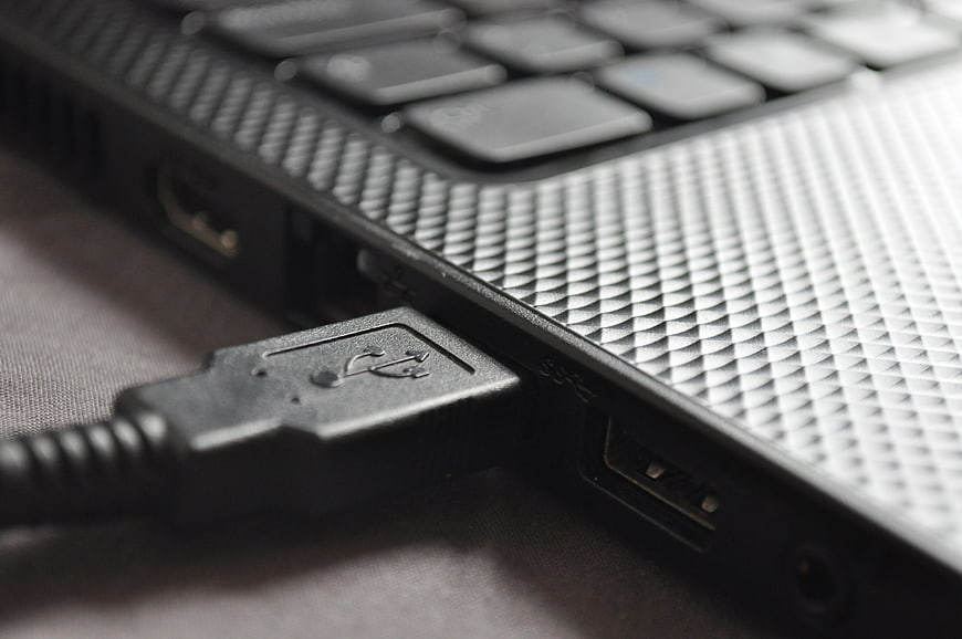 Close-up of USB cable plugged into laptop port