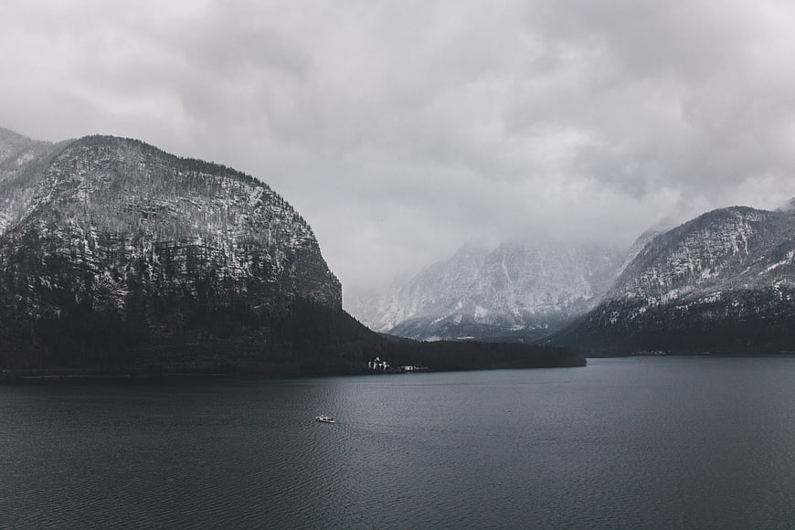 Snowy Mountains and Lake Landscape with Boat