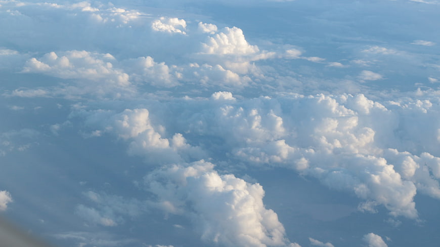 Aerial View of Fluffy White Clouds in Blue Sky