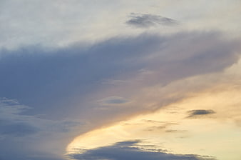 Dramatic sunset sky with golden light breaking through clouds