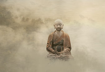 Meditating Buddha statue in misty mountain landscape