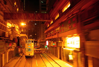 Motion blur of a tram on a neon-lit Hong Kong street at night
