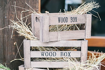 Stacked Wooden Crates with Hay and Text