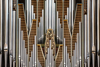 Symmetrical Close-Up of Silver and Gold Church Organ Pipes