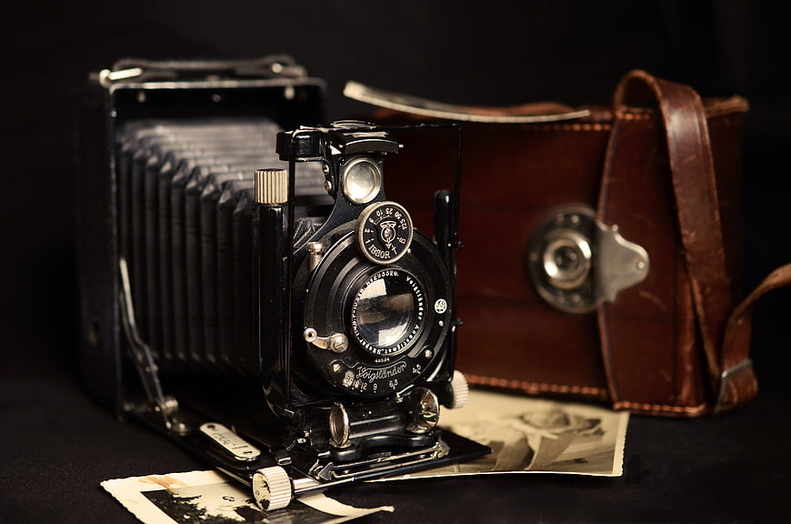Vintage Voigtländer folding camera with leather case and old photos