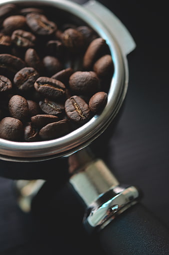 Close-up of roasted coffee beans in portafilter