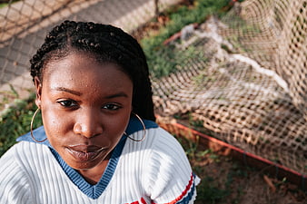 High angle portrait of young black woman with braids outdoors