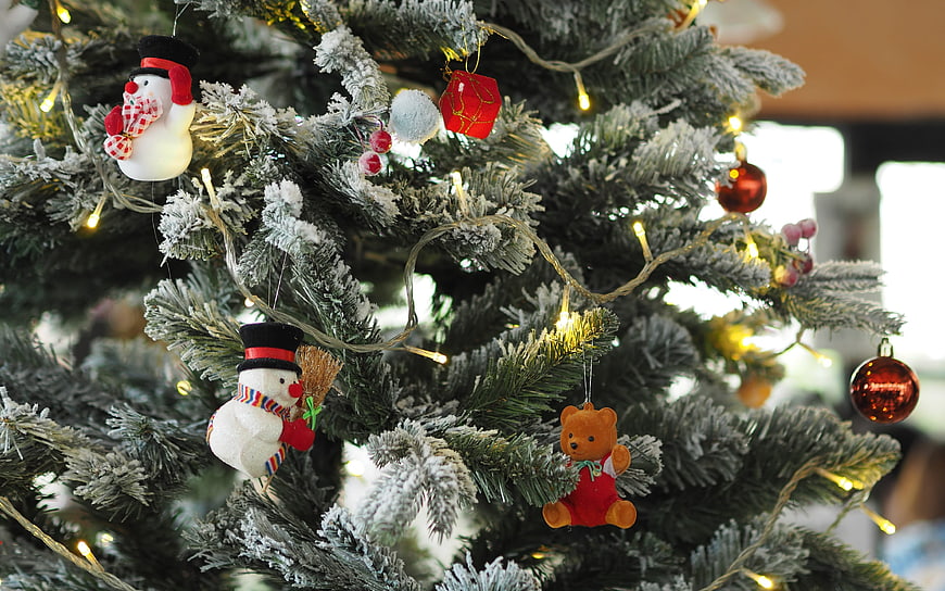 Close-up of Flocked Christmas Tree with Snowman and Bear Ornaments