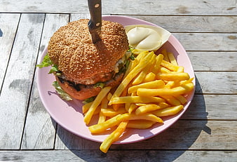 Delicious Burger with Fries and Mayo on Pink Plate