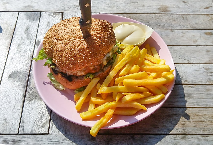 Delicious Burger with Fries and Mayo on Pink Plate