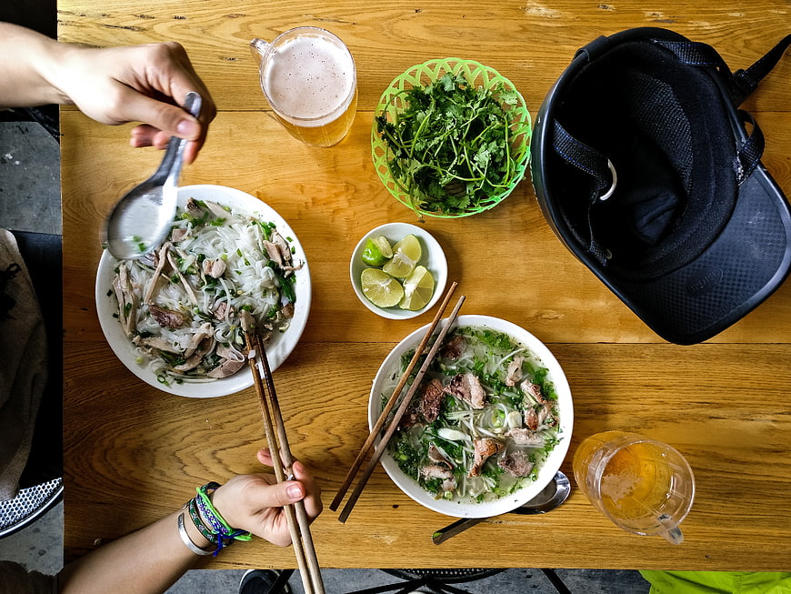 Top View of Vietnamese Pho Soup with Chopsticks and Lime