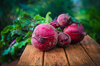 Fresh Beetroot on Wooden Table with Green Leaves