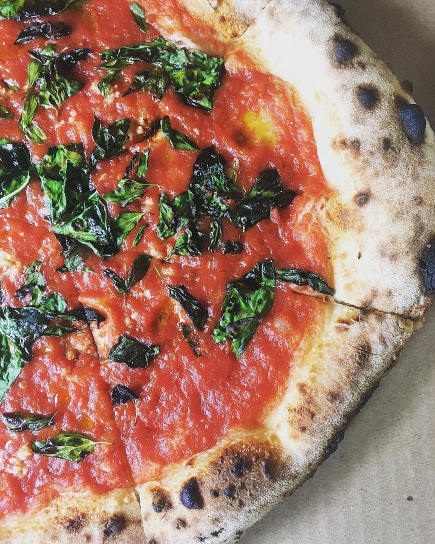 Close-up of authentic Neapolitan Margherita pizza with basil