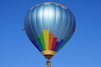 Colorful Hot Air Balloon Soaring in Blue Sky