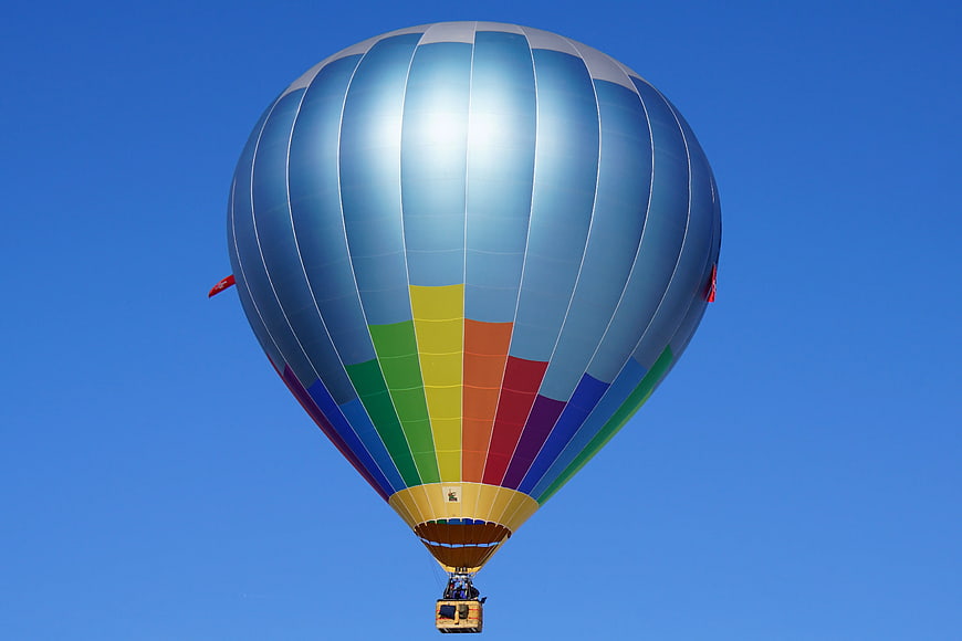 Colorful Hot Air Balloon Soaring in Blue Sky