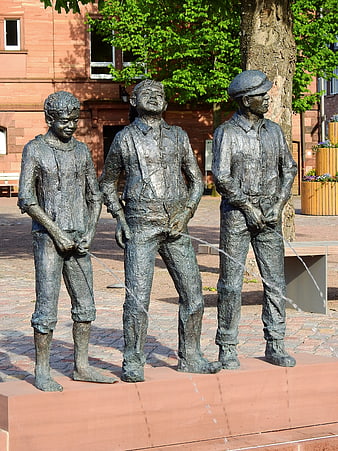 Three Bronze Statues of Men Urinating in Public Square
