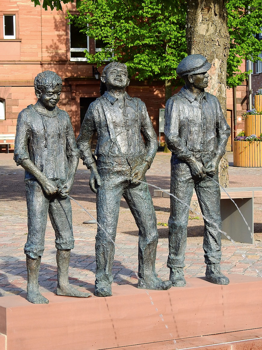 Three Bronze Statues of Men Urinating in Public Square