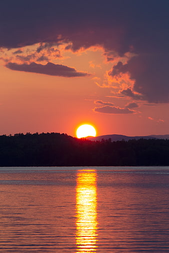Vibrant Sunset Over Lake With Forest Silhouette