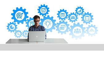 Young businessman working on laptop with business gear icons