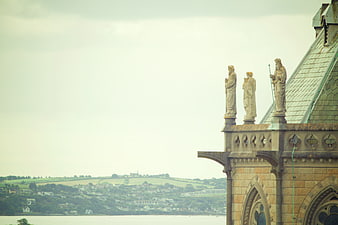 Gothic Cathedral Statues Overlooking Irish Coastal Town