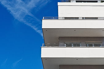 Modern White Apartment Balconies Against Blue Sky