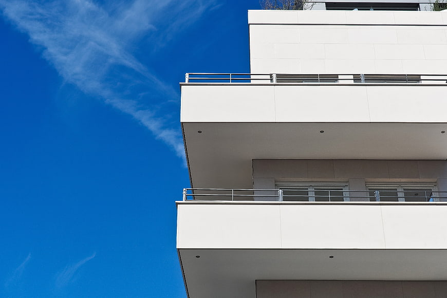 Modern White Apartment Balconies Against Blue Sky