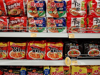 Korean instant noodle packages on supermarket shelves