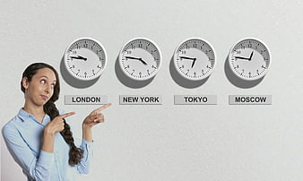 Businesswoman Pointing At World Clocks For Time Zones