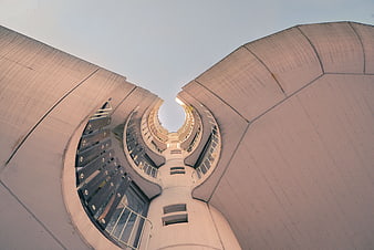 Low angle view of curved modern concrete architecture