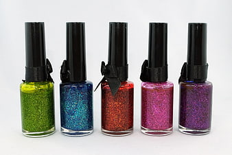 Five Glitter Nail Polish Bottles With Black Caps And Ribbons