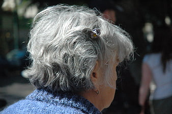Senior Woman with Gray Hair and Flower Clip
