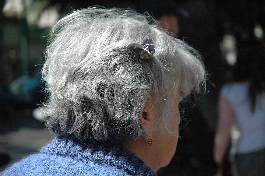 Senior Woman with Gray Hair and Flower Clip