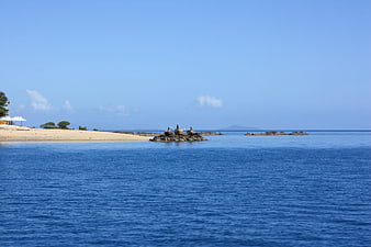 Serene coastal landscape with blue water and sandy beach