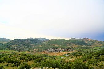 Scenic village nestled in green mountain valley landscape