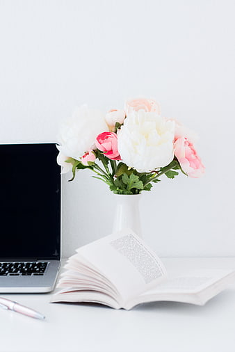 Minimalist White Desk Setup With Laptop, Open Book, And Pink Peony Bouquet