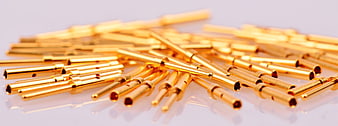 Gold Plated Electrical Connectors Scattered On White Surface