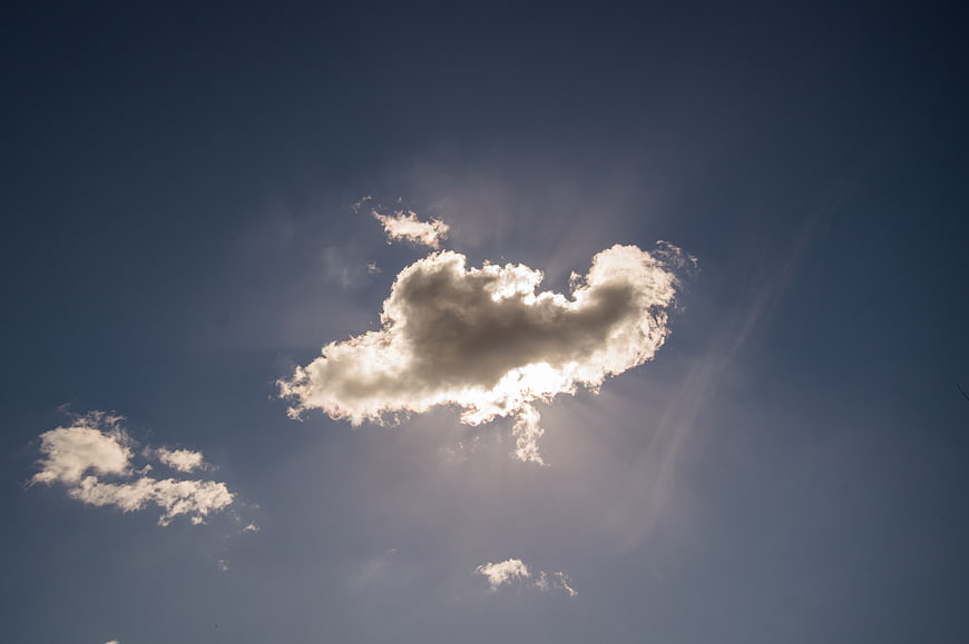 Dramatic Sun Rays Through Clouds in Blue Sky