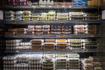 Assorted egg cartons in a refrigerated grocery store display