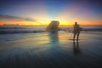 Silhouette of Photographer Capturing Sunset on Beach