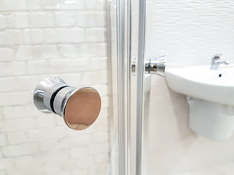 Close-up of modern chrome and copper bathroom door handle