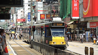 Hong Kong Tram on Busy Urban Street with Pedestrians
